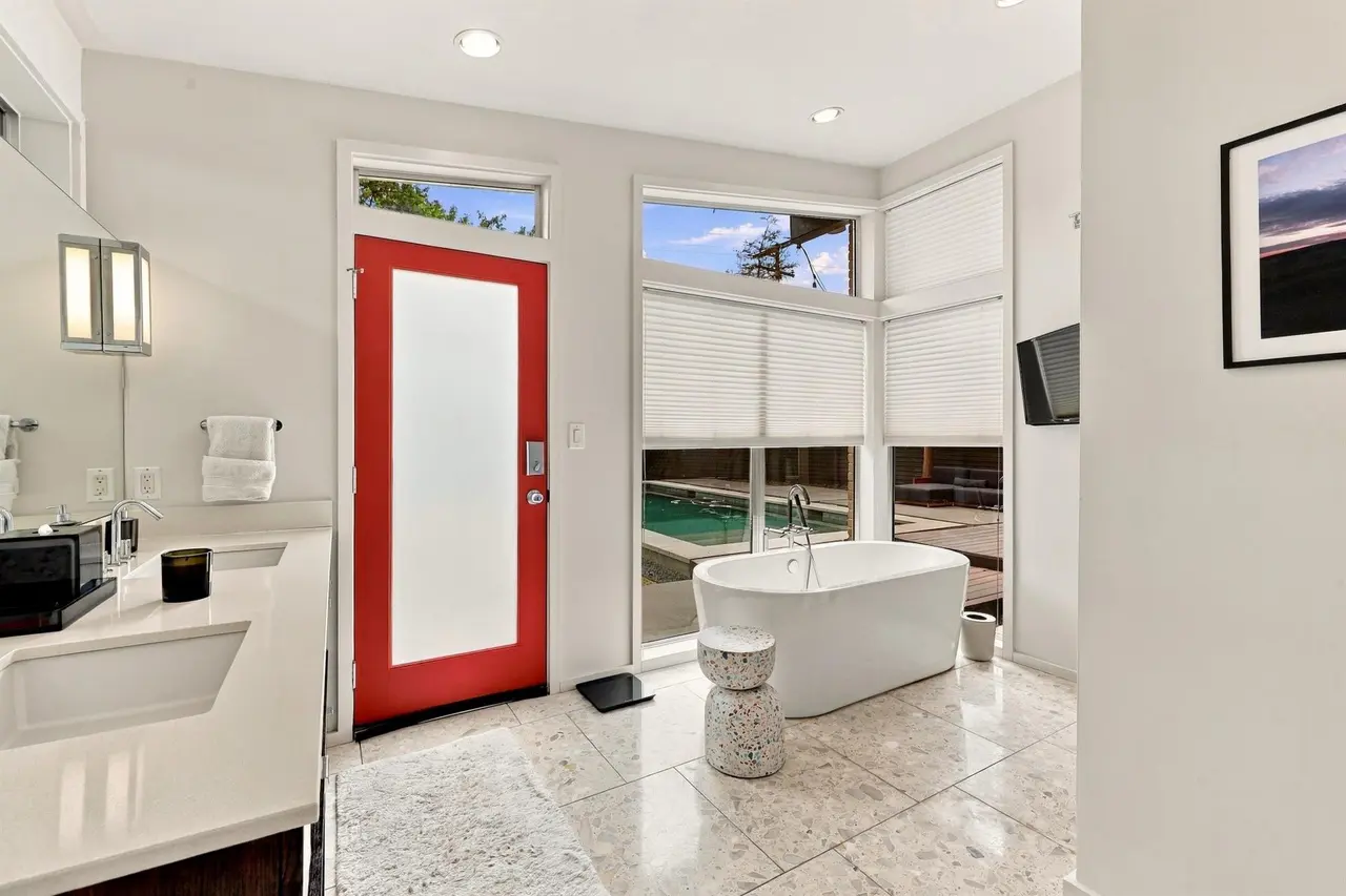 Most of the interior design is neutral hues: black, white, and light wood, but there are random pops of bright red and yellow as well. 