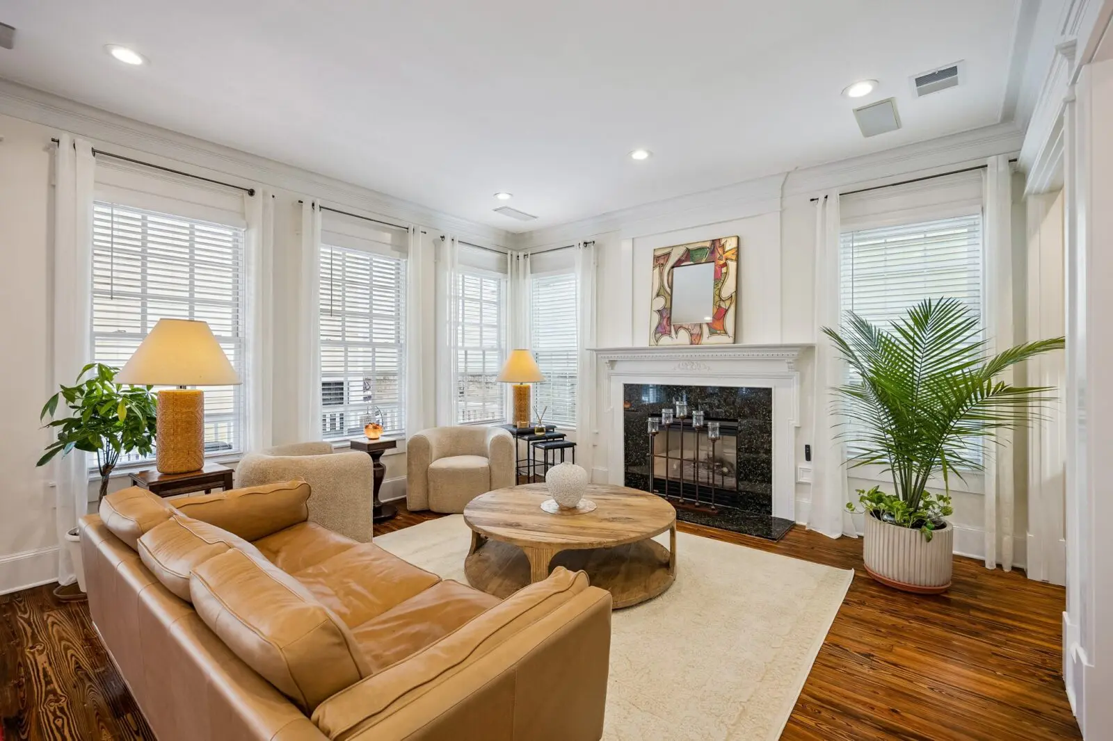 The cozy gas fireplace and wet bar make this living area in the main house at 216 E. 26th Street a comfortable retreat. (Photo by TK Images for Martha Turner Sotheby's International Realty)