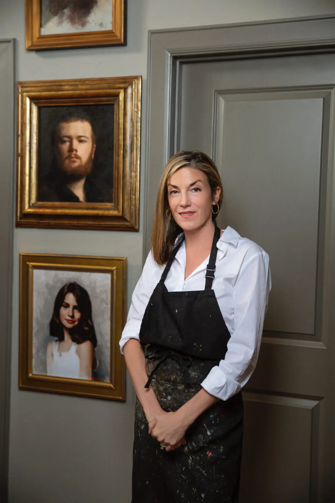 Sarah Lamb stands in her husband's studio. The couple is a rare example of married artists painting in different genres of realism. (Photo by Jenny Antill Clifton)
