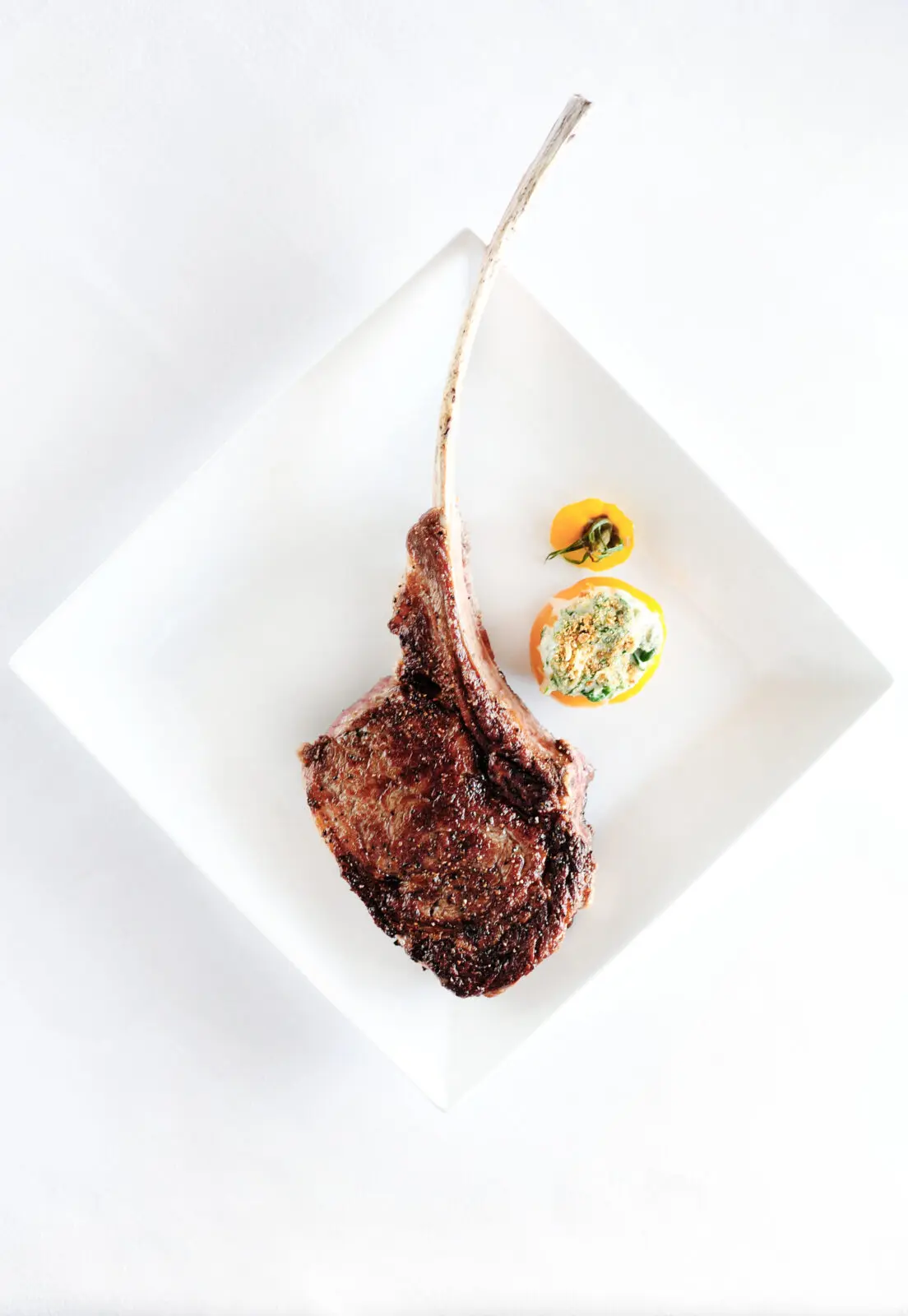 Dig into a long bone Tomahawk ribeye and the newly revamped Killen's Steakhouse in Pearland, Texas. (Photo by courtesy of Killen's Steakhouse)