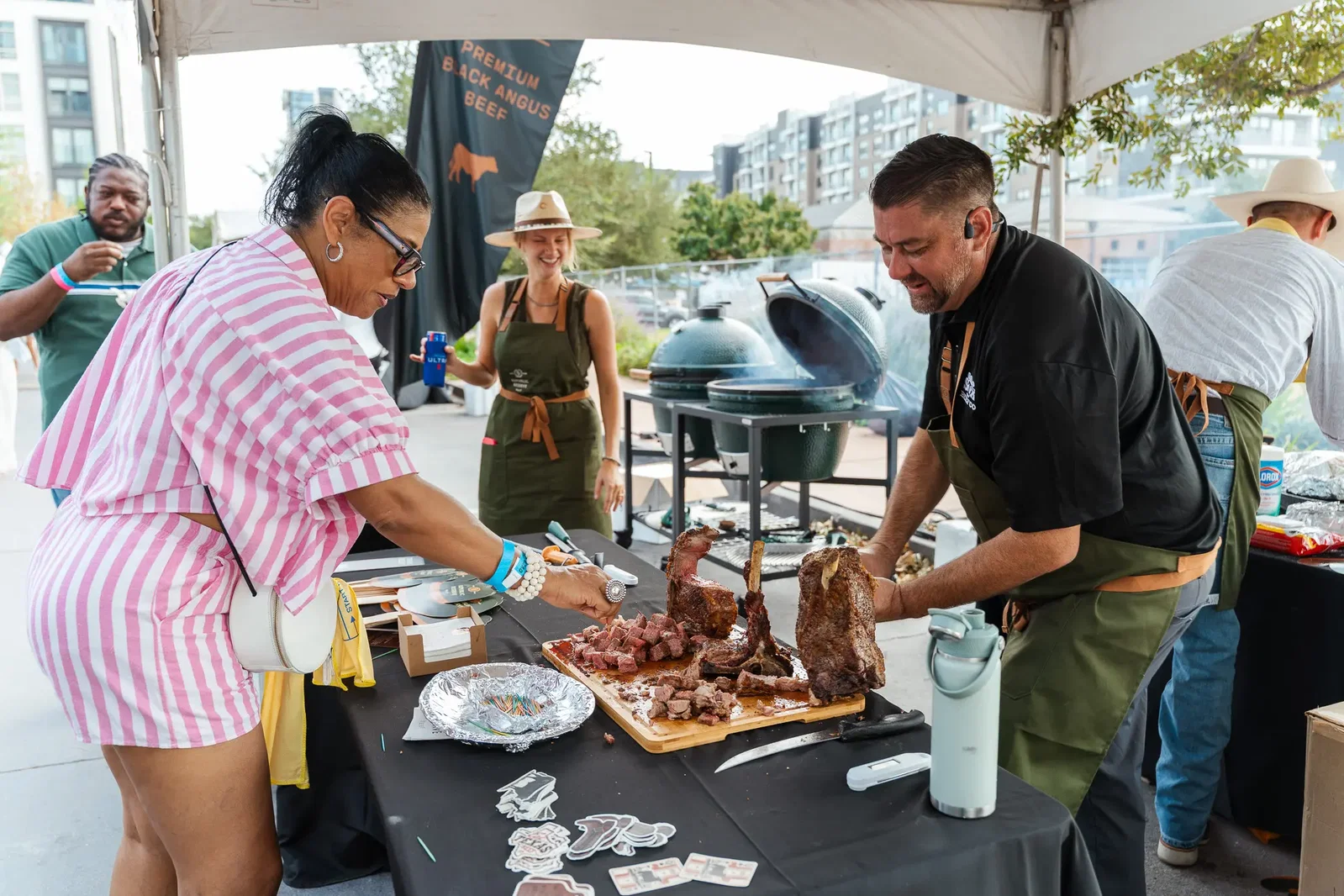 Attendees taste Wood-Fired Republic Reserve Beef Tomahawk