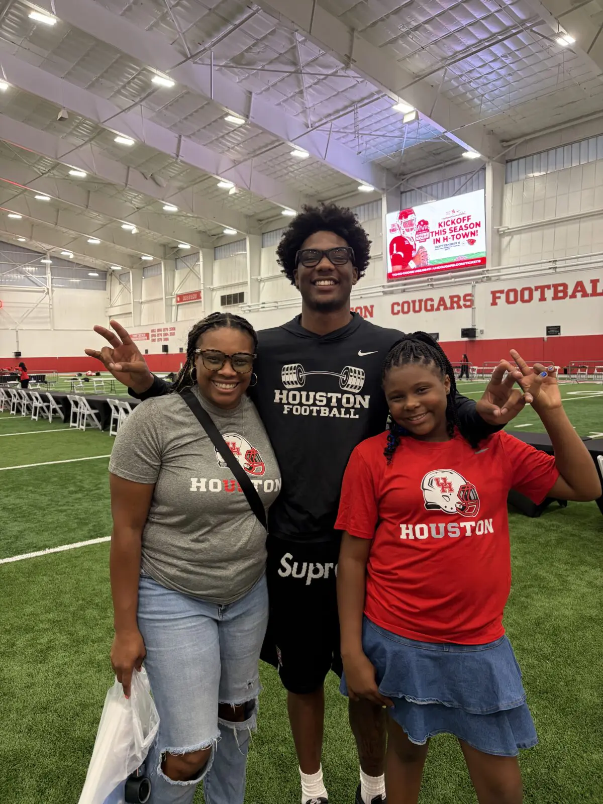 Erica Henderson, Keisean Henderson and his younger sister Keiara Henderson have a moment after a University of Houston football win. (Courtesy Erica Henderson)
