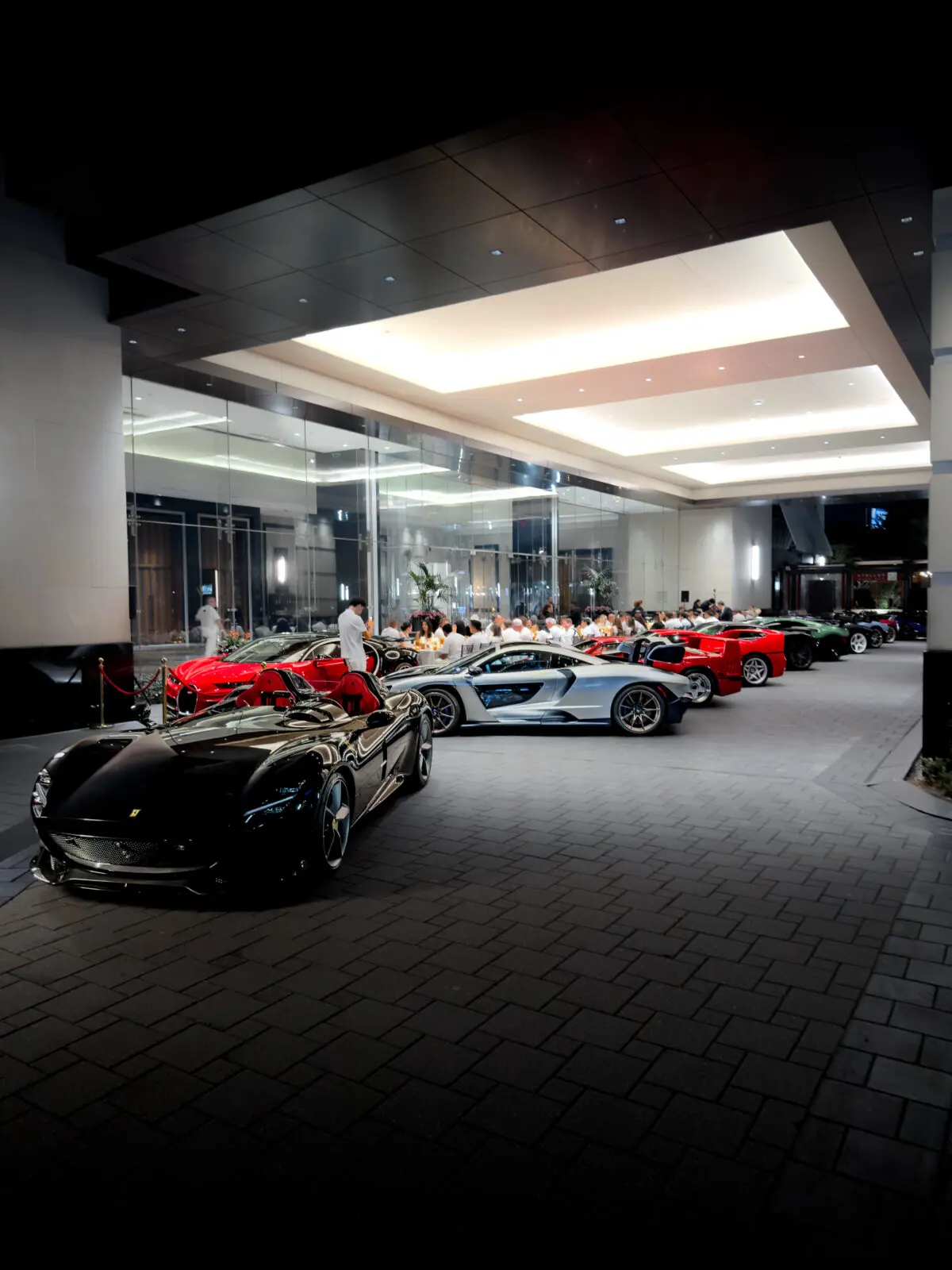 The collection of exotic cars lined up in the porte cochère at the Post Oak Hotel ballroom for the Collectors Dinner.  (Photo by The Exchange Network)