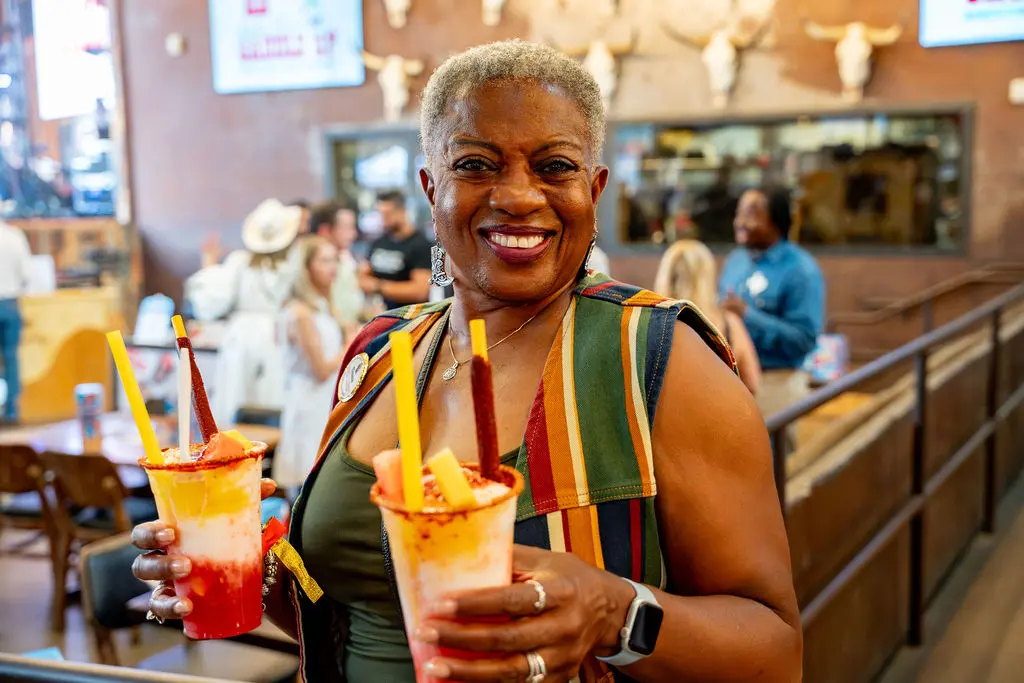 Melanie Linear enjoys State Fair-inspired fare at Saddle Up 2026. (Photo by Imani Black)