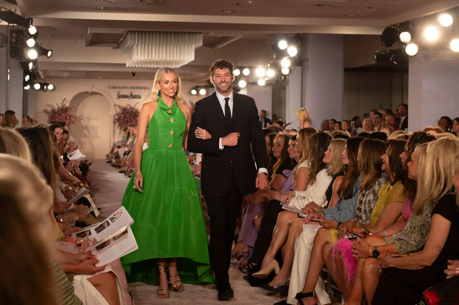 Shelby Goff walked the runway in a Carolina Herrera "lawn green" collared halter ball gown with golden brooch-inspired buttons and a voluminous pleated skirt.  (Photo by Tamytha Cameron and Celeste Cass)