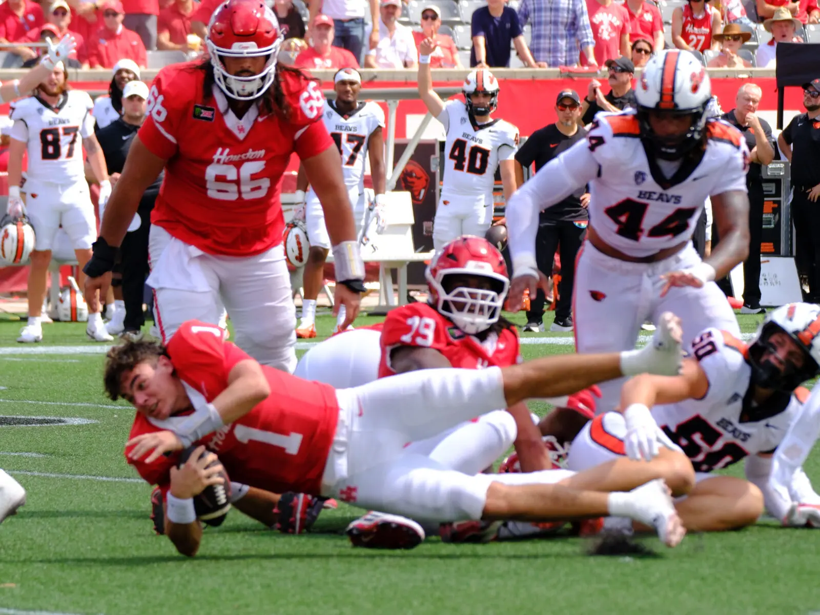 University of Houston quarterback Conner Weigman is always stretching for the extra yard. Even when his helmet comes off.  (Photo by F. Carter Smith)