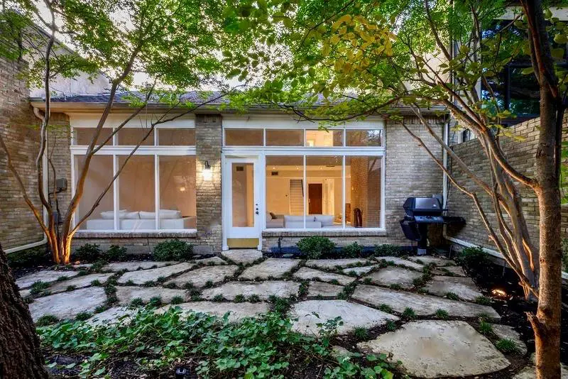The mid-century modern home at 4650 Christopher Place is a rare find with its private patio garden and creekside park.