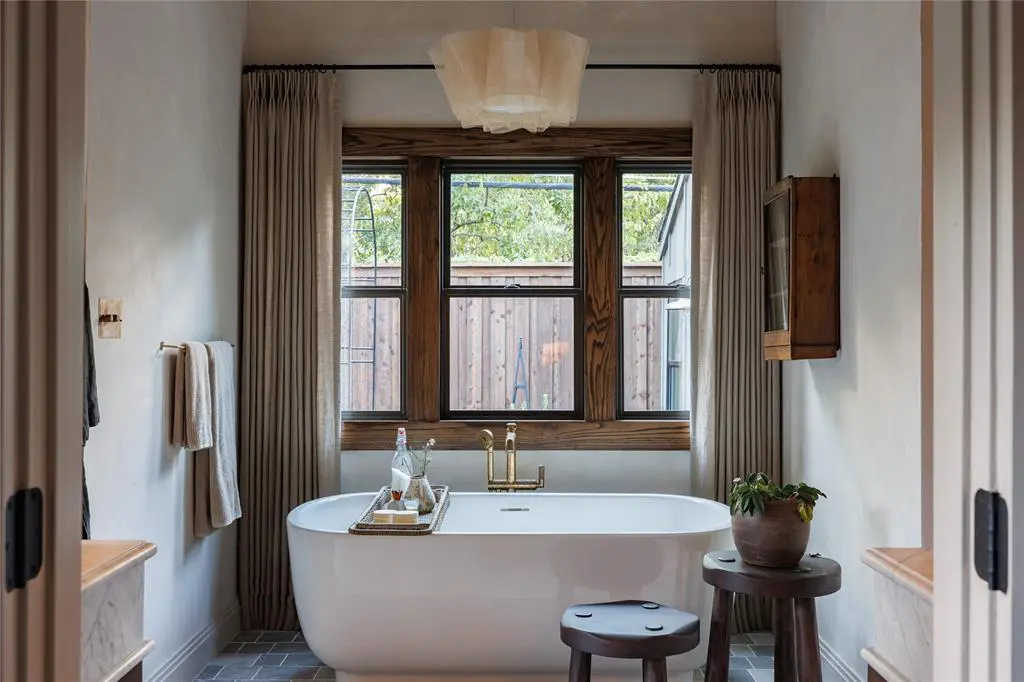 In 6861 E Mockingbird Lane's primary bath, a freestanding soaking tub captures the attention. 