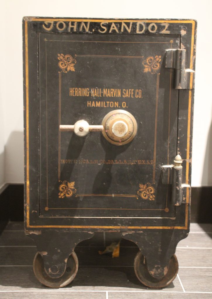 The safe belonged to the gallerist's maternal great-grandfather, who had a thriving produce business in St. Louis. It now functions as a night stand in his bedroom, adding a touch of familial history.