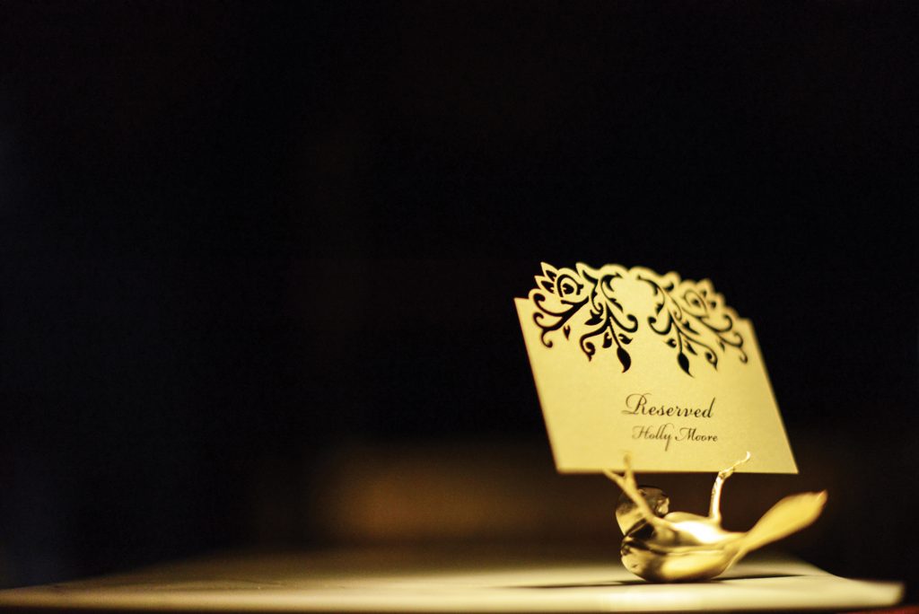 A golden tufted titmouse by Sparrow holds a
reserved card on a table in the restaurant.