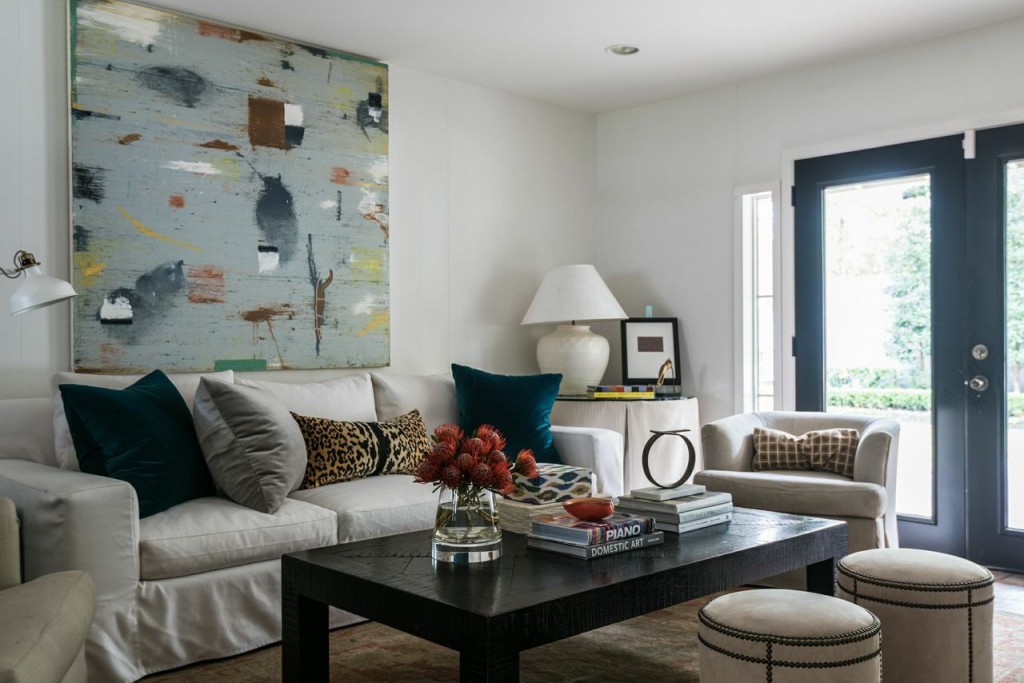 In the family room: sofa by Ashley Goforth Design in Sunbrella fabric, coffee table from Crate and Barrel, side table by Perennials Fabric, lamp from Wisteria, rug purchased in Istanbul, Turkey, throw pillows fabric from Kravet and artwork- Larry Grabber through Gremillion.
