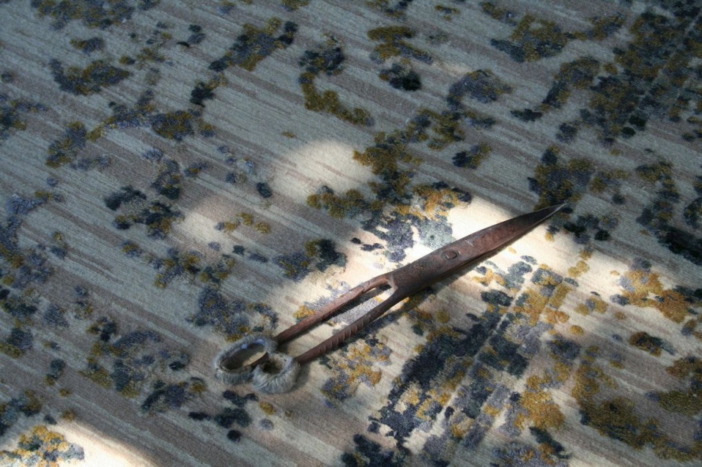 Even this modern design is still finished by hand. After the carpet is washed and dried craftsmen scissor and rough spots in the pile clean with these purely archaic looking shears.