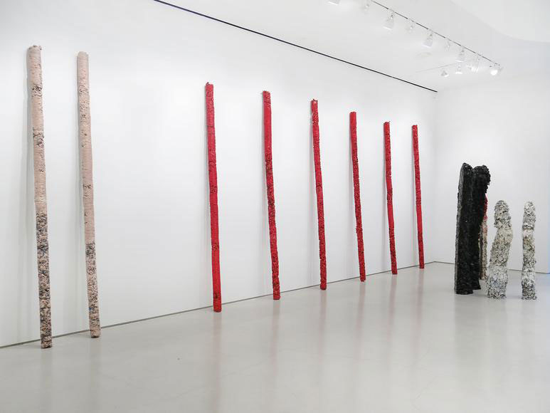 Approximately 200 resin-and-pigment totems stand like ghostly presences.  