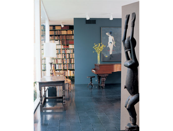 In the living room, the steel-gray wall is an early version of what will come to be known as "Menil gray." 