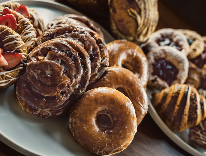 Strawberry Danishes, apple fritters, glazed donuts and croissants