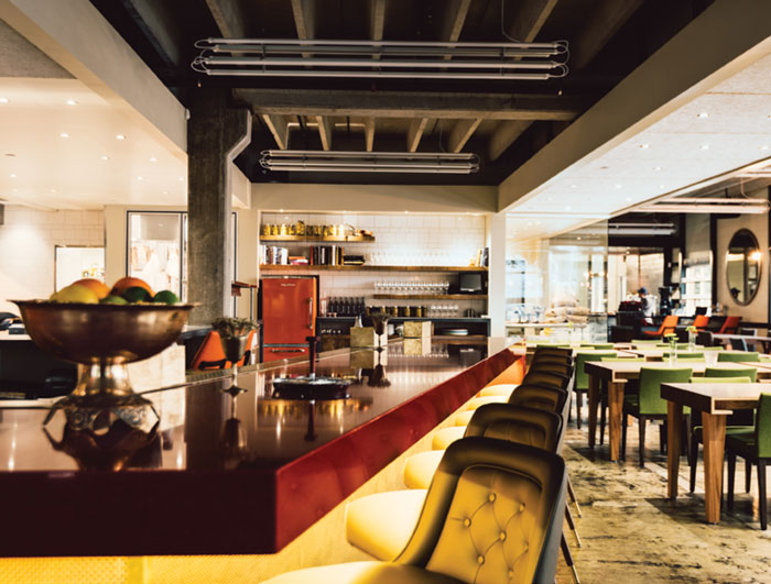 View of dining room and open kitchen from bar