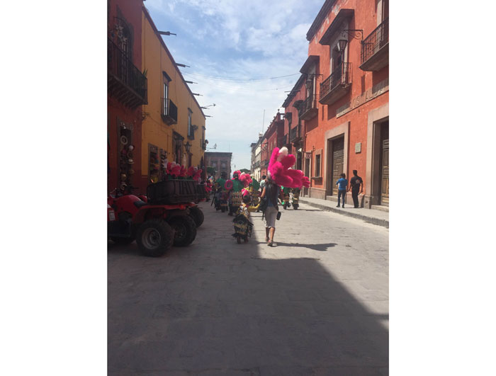 Locals strolling through the cobblestone streets in the city center.