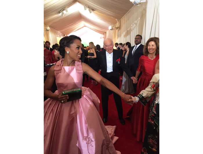 Kerry Washington, wearing Prada, behind us on the red carpet 