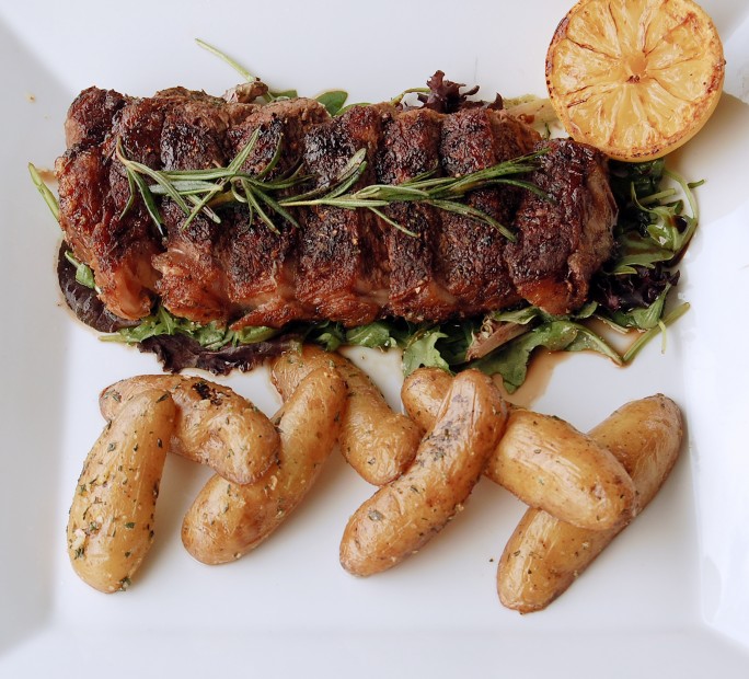Sud Italia Ristorante's NY Tagliata, New York steak with a balsamic reduction over a bed of radicchio and arugula served with fingerling potatoes; Photo courtesy Sud Italia