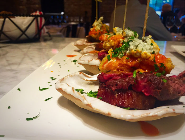 Carpet Bagger on the half shell – fried oysters atop thick cut bacon, topped with blue cheese