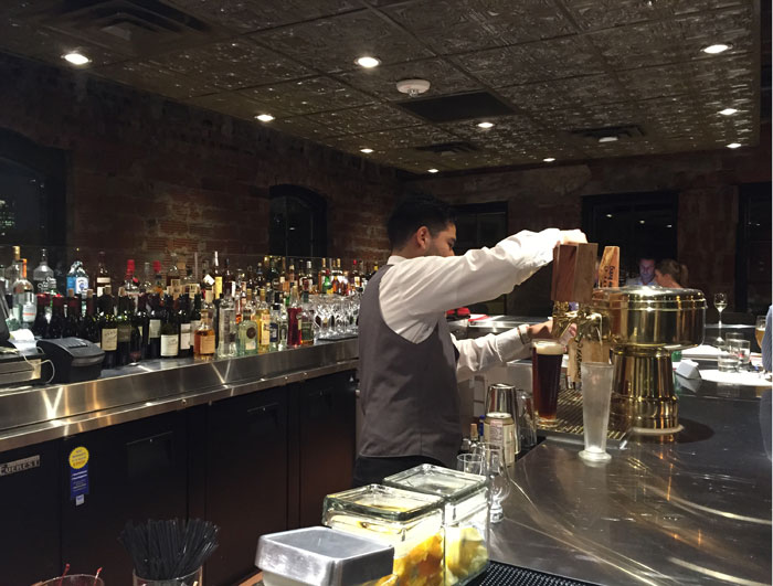 Bartender prepares drinks at B&B's second-floor bar.