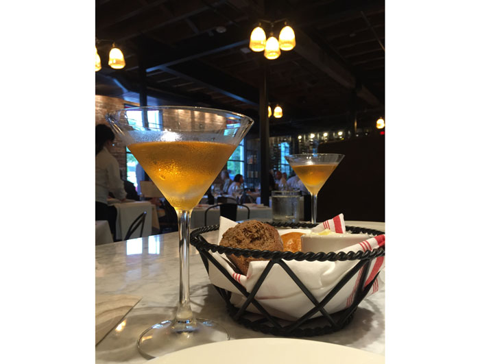 The Haymaker cocktail accompanied by an assorted bread basket 