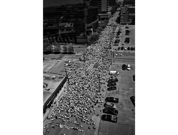 "Immigrant Reform Protest," snapped by Sharum in Dallas in 2006, highlights the photographer's social conscience. View it al fresco on the facade of 800 Main Street through June 7. 