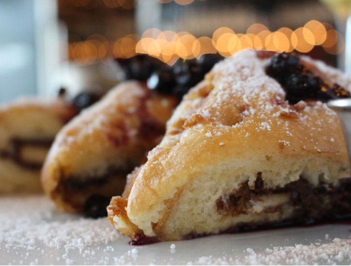 Hong Kong style french toast at Max's Wine Dive. Crème brûlée battered French toast stuffed with bananas and Nutella in a buttermilk batter, fried and topped with a honey-blueberry marmalade.