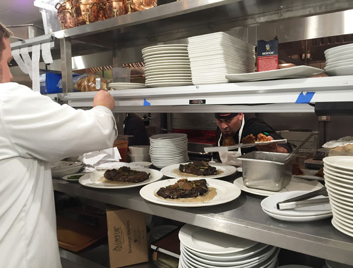 Line cooks prepare dishes for service.