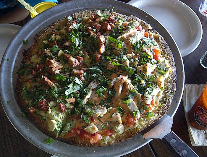Gateway of India pizza at Bombay Pizza Co. Tandori chicken, fresh crabmeat, artichoke hearts, provolone and mozzarella on cilantro-mint chutney.  