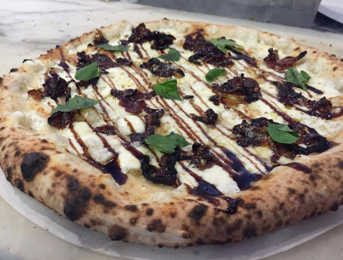 A pizza of the day at Pizaro's. Garlic, olive oil, crispy prosciutto and speck caramelized onions finished with a balsamic glaze. Photo courtesy Pizaro's Facebook Page. 