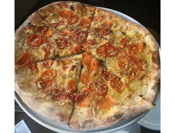 Roasted carrot pizza at Weights + Measures. Roasted carrots, redneck cheddar, sauce soubise and dukka.