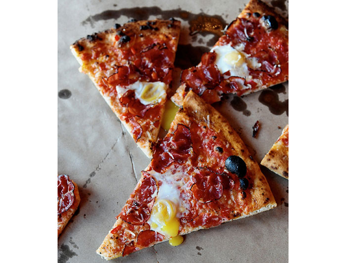 Coppa "ham & eggs" pizza at Coppa Osteria. Spicy air-dried pork shoulder, quail eggs, tomato and parmesan.