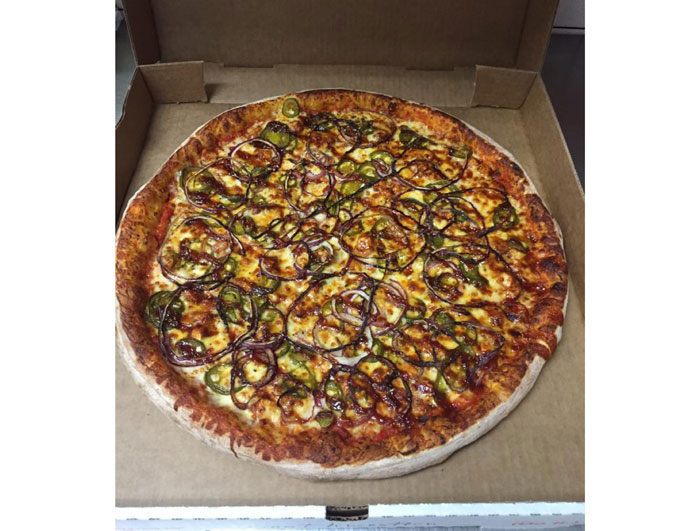 Southwestern pizza pie at Pink's Pizza. BBQ marinated chicken breast, red onions, jalapeños, mozzarella and cheddar cheese. 