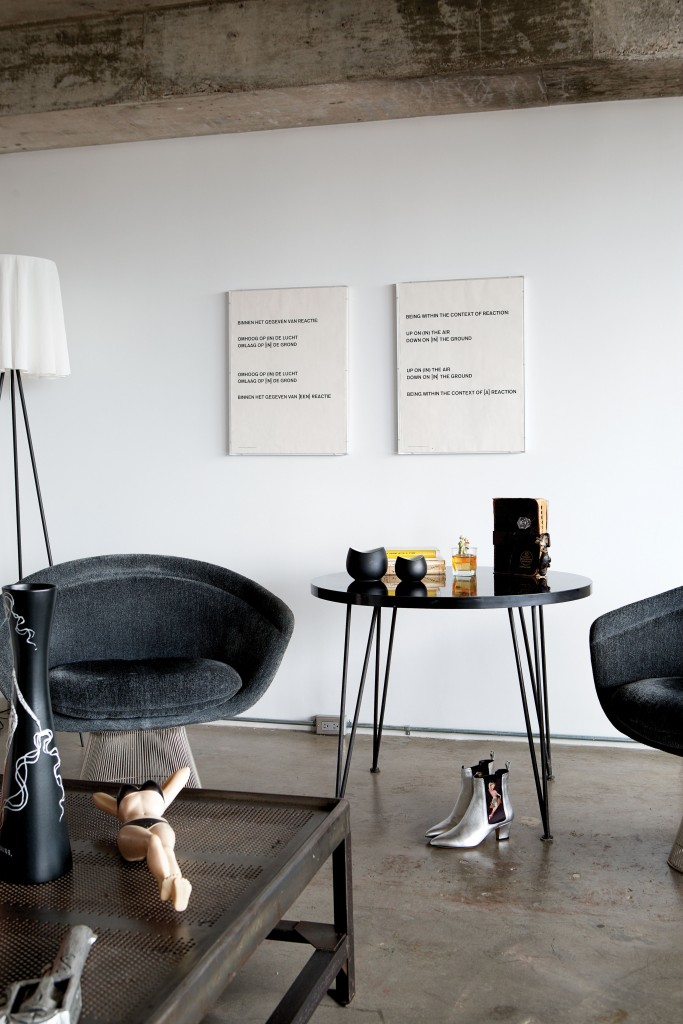 Word-based artwork by Lawrence Weiner is in Dutch and English. Vintage Platner chairs. Italian Rupert
Sanderson ankle boots.