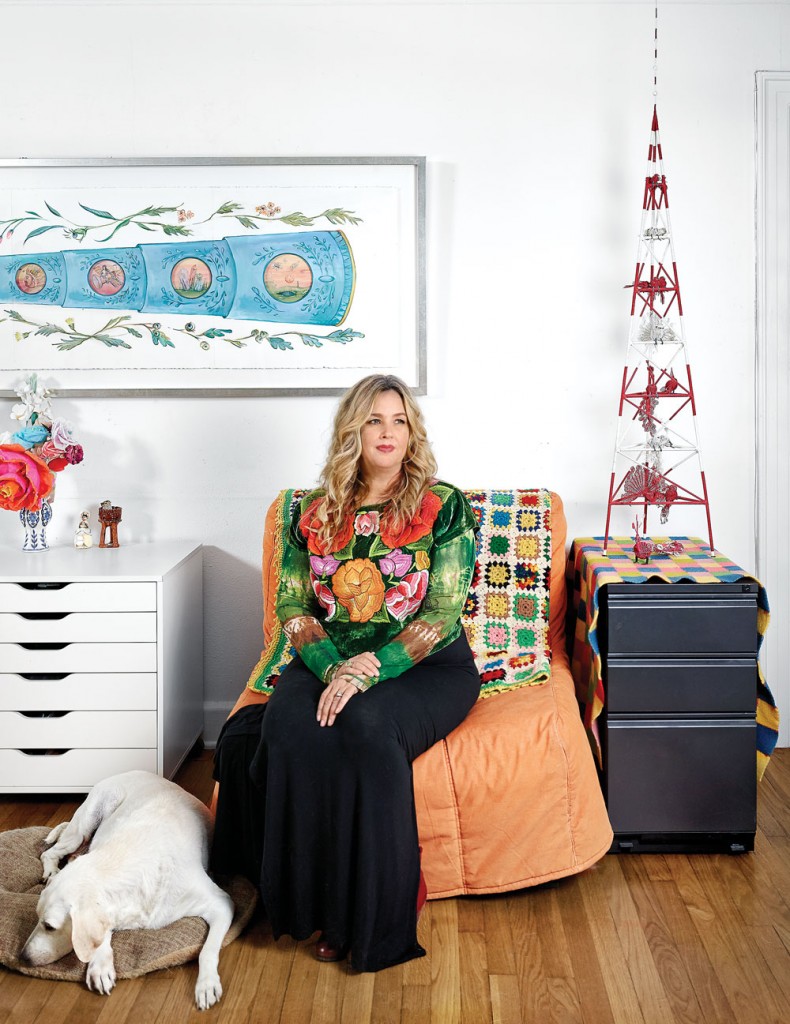 Amber Eagle in her living room with Lula. She wears a huipil garment — sewn by women from the Tehuantepec region — indicative of her passion for Mexican artisanship.