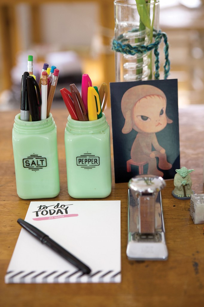 Vintage salt-and-pepper shakers hold pencils
and markers. The notepad is Jill’s own design, available at Tiny Prints. Print of Yoshitomo
Nara’s Sleepless Night Sitting. Yoda figure given to Jill from her dad when she started driving. “He sat on my dashboard and watched over me,” she says. Vintage drafting table from her childhood home.
