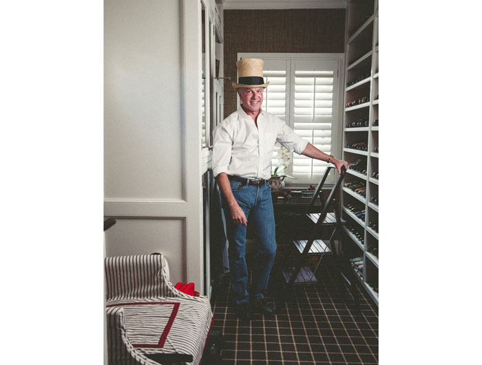 J. Randall Powers models a top hat inside his glorious closet