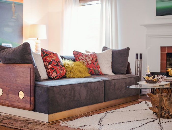 In the living room, the walnut-sided De La Espada sofa from Portugal is from Jon Tutolo's former store, Haven. The embroidered pillows are made from textiles sourced from photostylist Jimmie Henslee and sewn by women employed through Gaia.