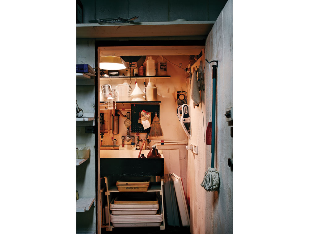 The darkroom includes
a basin, chemical trays
and bottles of developing fluid, among other tools of the trade.