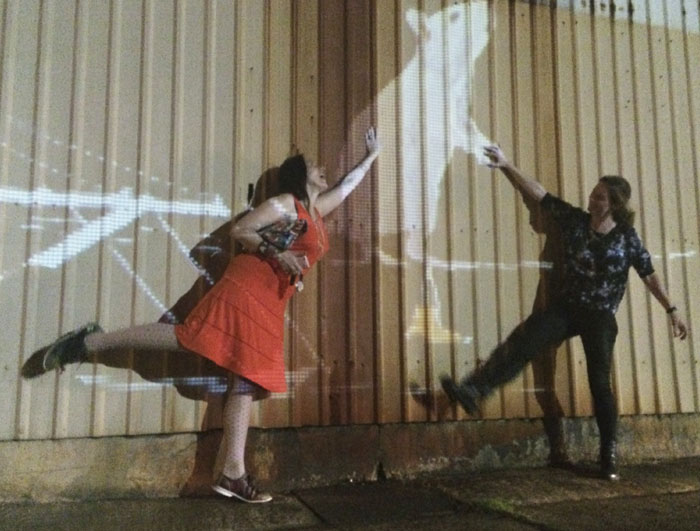 This scribe joins the artist in cavorting with the art. Photo Mary Margaret Hansen. 