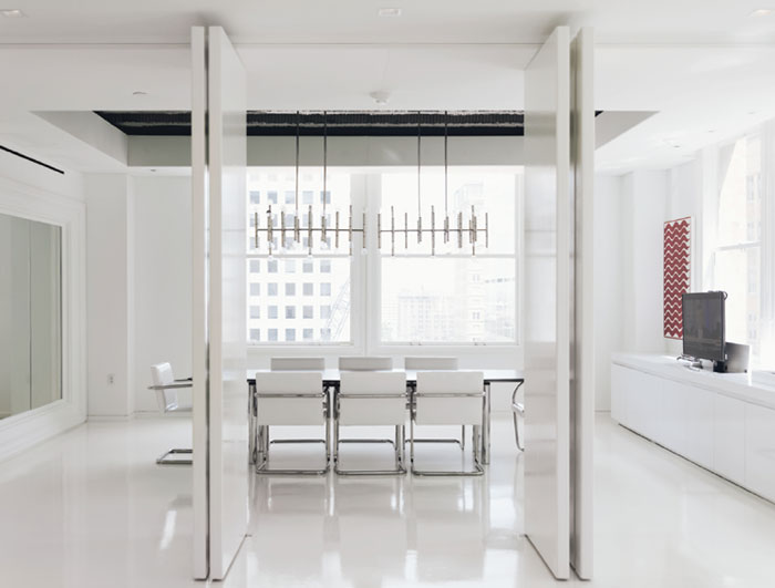 In the conference room, Jonathan Adler Meurice chandelier and vintage Knoll table and Brno chairs.