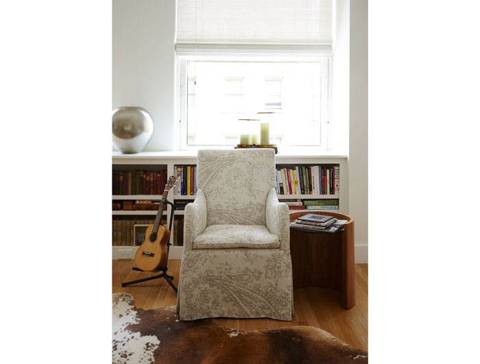 A chair upholstered in Peacock Alley linen fabric. Walnut side table purchased from the Peacock Alley showroom. The ukulele belongs to John Bitzer.