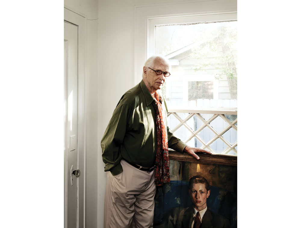 Fred Baldwin with a portrait of himself at age 18, painted by American artist Louis Betts.