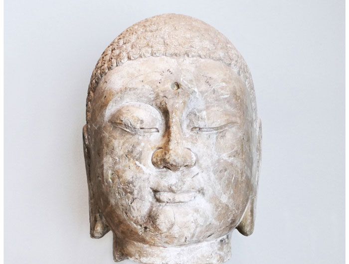 A serene marble Buddha greets gallery-goers upon their arrival on the second floor, a work of art from China's Northern Qi dynasty (A.D. 550-577) or Sui dynasty (A.D. 581-618).