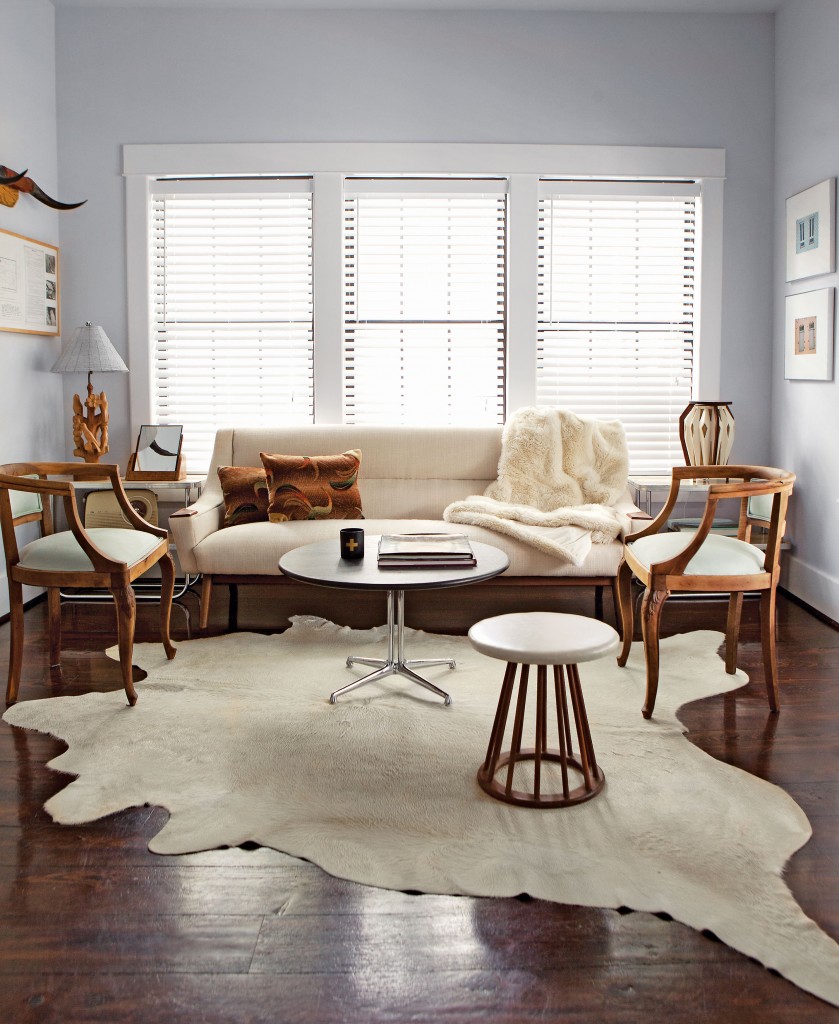 The front-of-the-house sitting room mixes decades and attitude in a polite, polished design dialogue. Holding pride of place: a languid mid-century modern sofa by Folke Ohlsson for Dux, a find from Reeves Antiques. Flanking the sofa, graceful European chairs from Antiques and Interiors on Dunlavy (now at the Pavilion). Slate-and-chrome coffee table and a mod stool, both from Metro Retro. Cowhide rug from Heights Antiques on Yale.