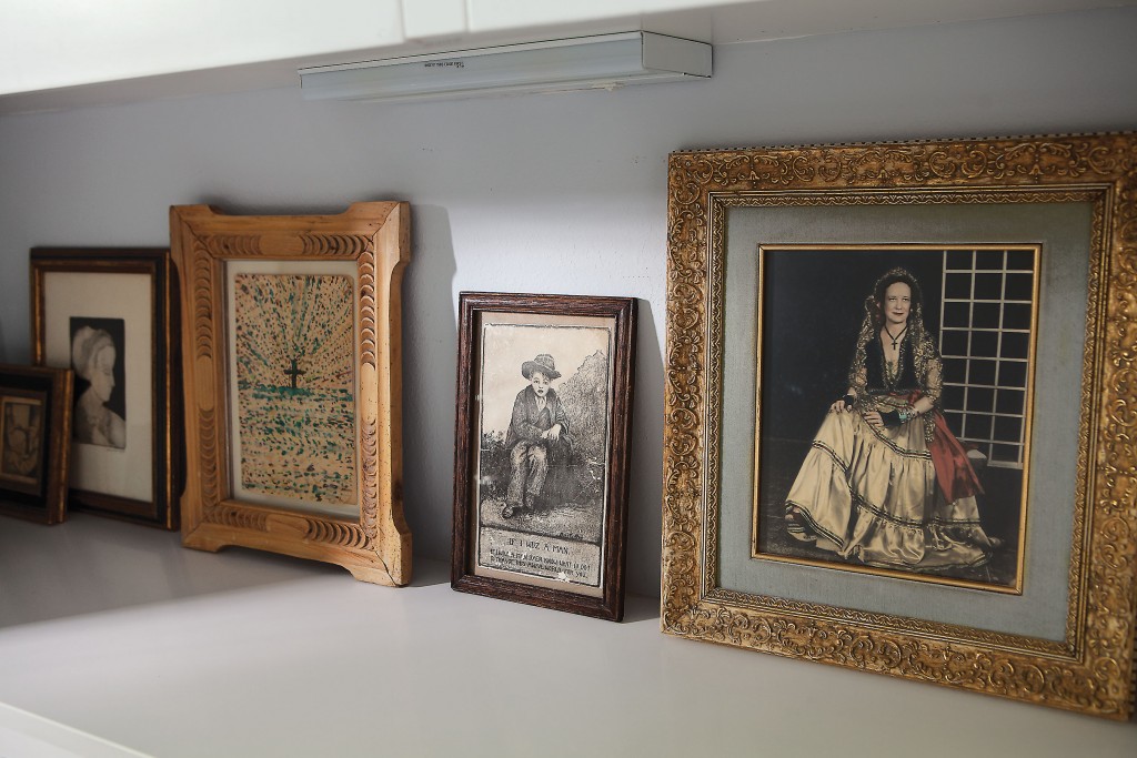 In a shelf in the guest bath, a lineup of favorite images holds court, including, far right, Cusack’s paternal grandmother in fancy costume dress.