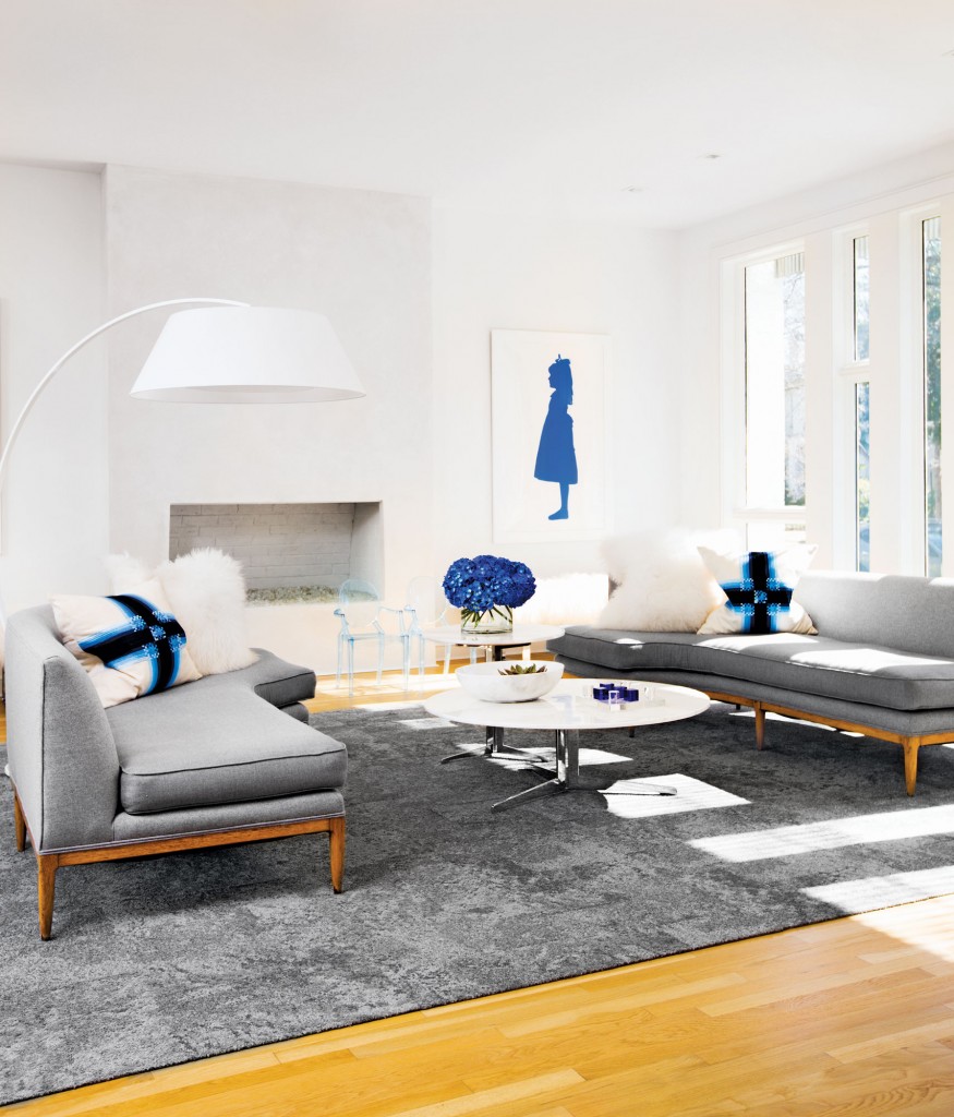 In the front living room, a pair of vintage sofas covered in men’s flannel suiting from Hadleigh’s. Jonathan Adler pillows. Tables, Ghost chairs and fl oor lamp from Scott + Cooner. Flor carpet squares. Silhouette of GG by Fredrik Broden.