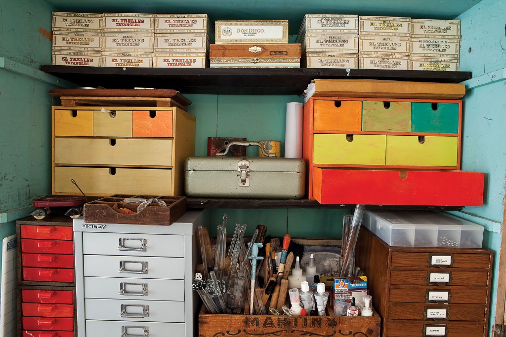 Tools, drawers and her dad’s cigar boxes line a work cabinet.
