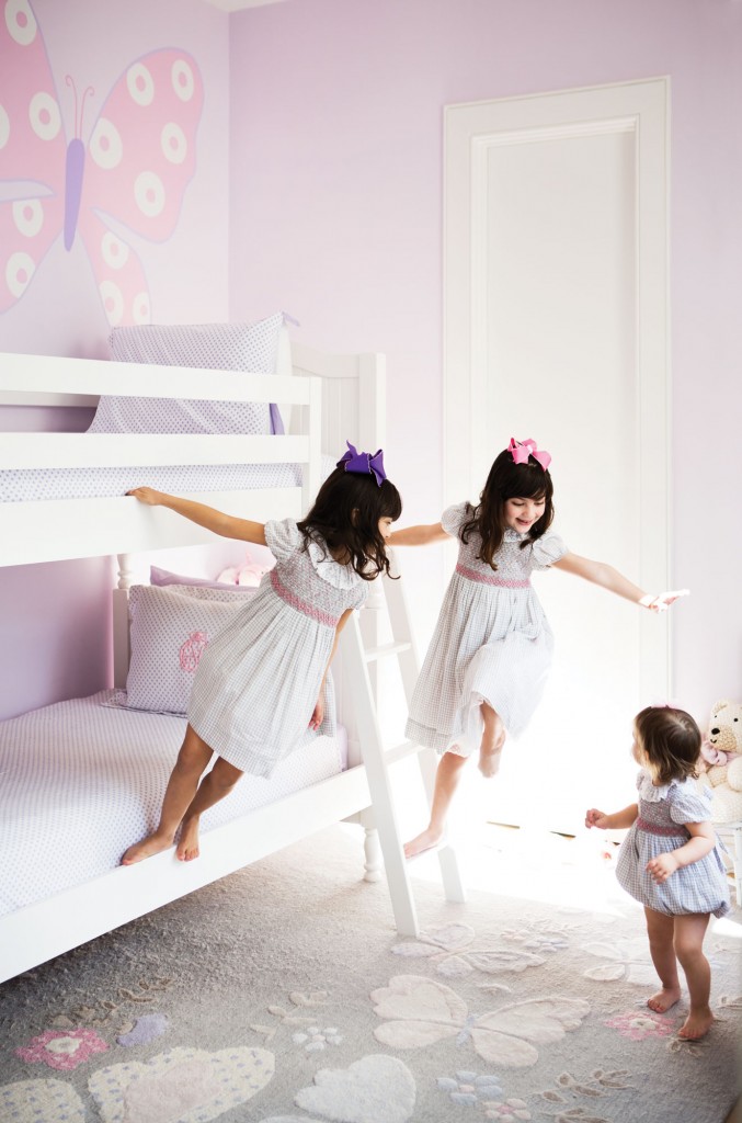 From left, GG, Hadleigh and Everleigh play in GG’s room. Bunk beds and rug from Pottery Barn Kids. Hand-painted butterfl y on wall.